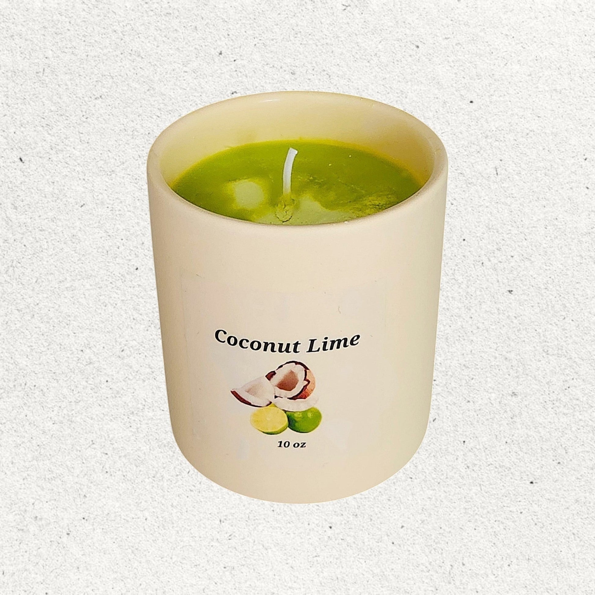 Green candle in a pale yellow ceramic tumbler with an image of limes and coconuts and the title Coconut lime