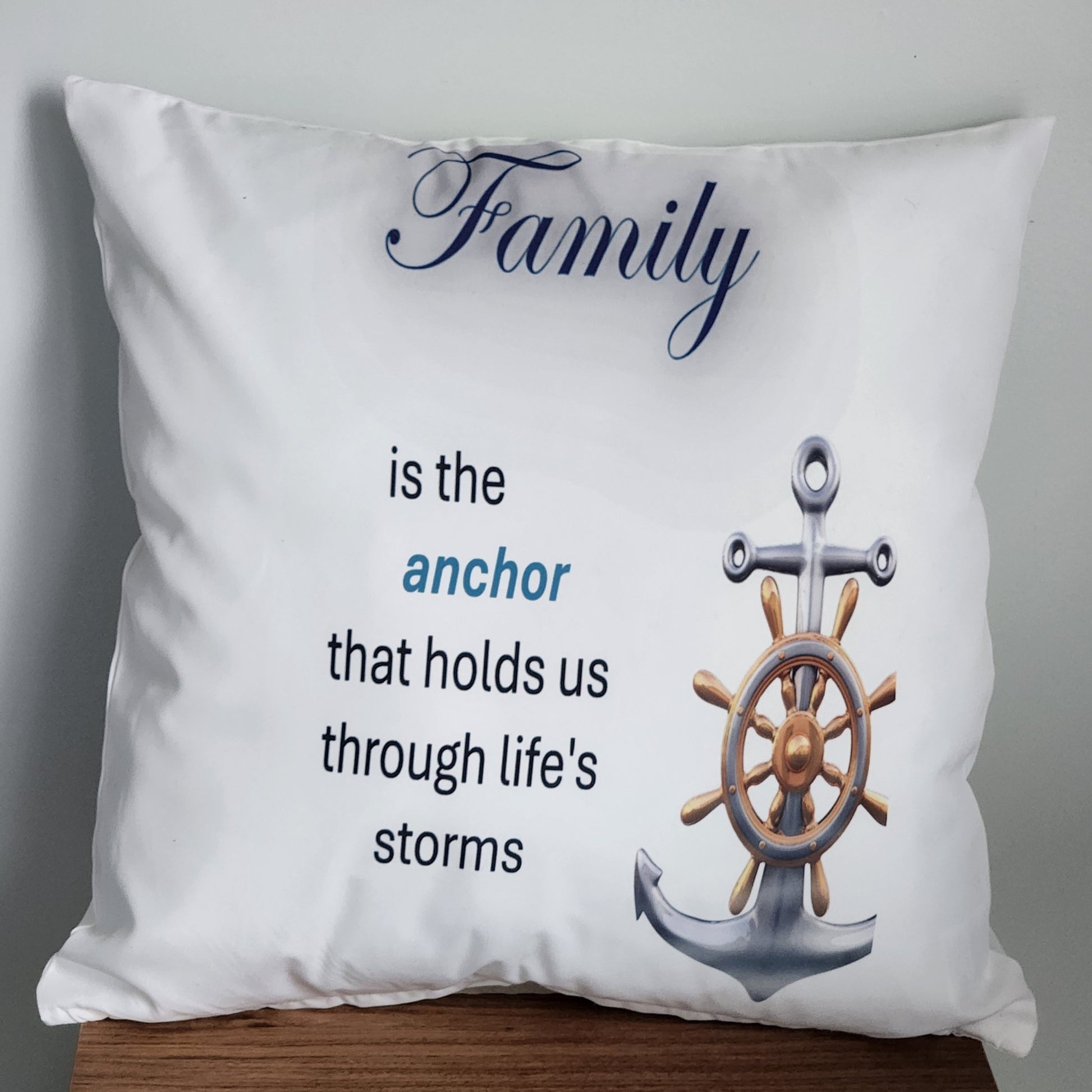 Decorative pillow with an anchor, steering wheel, and family quote on a white background